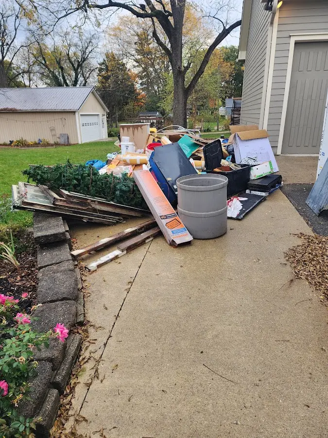 Dumpster being loaded with debris for 3 Yard Dumpster Rental in Massapequa Park